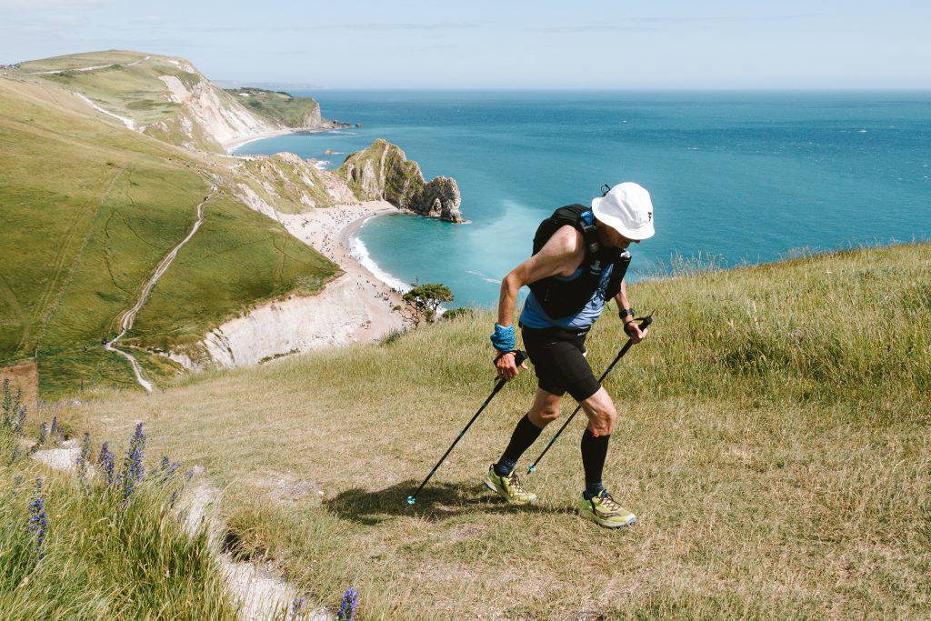 Jurassic Coast. An image of a hiker crossing over the Devon moors by foot.