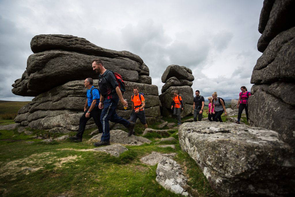 An image of a group of people hiking in a valley.