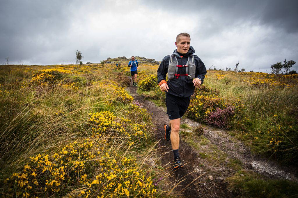 An image of a group of people jogging in a field.