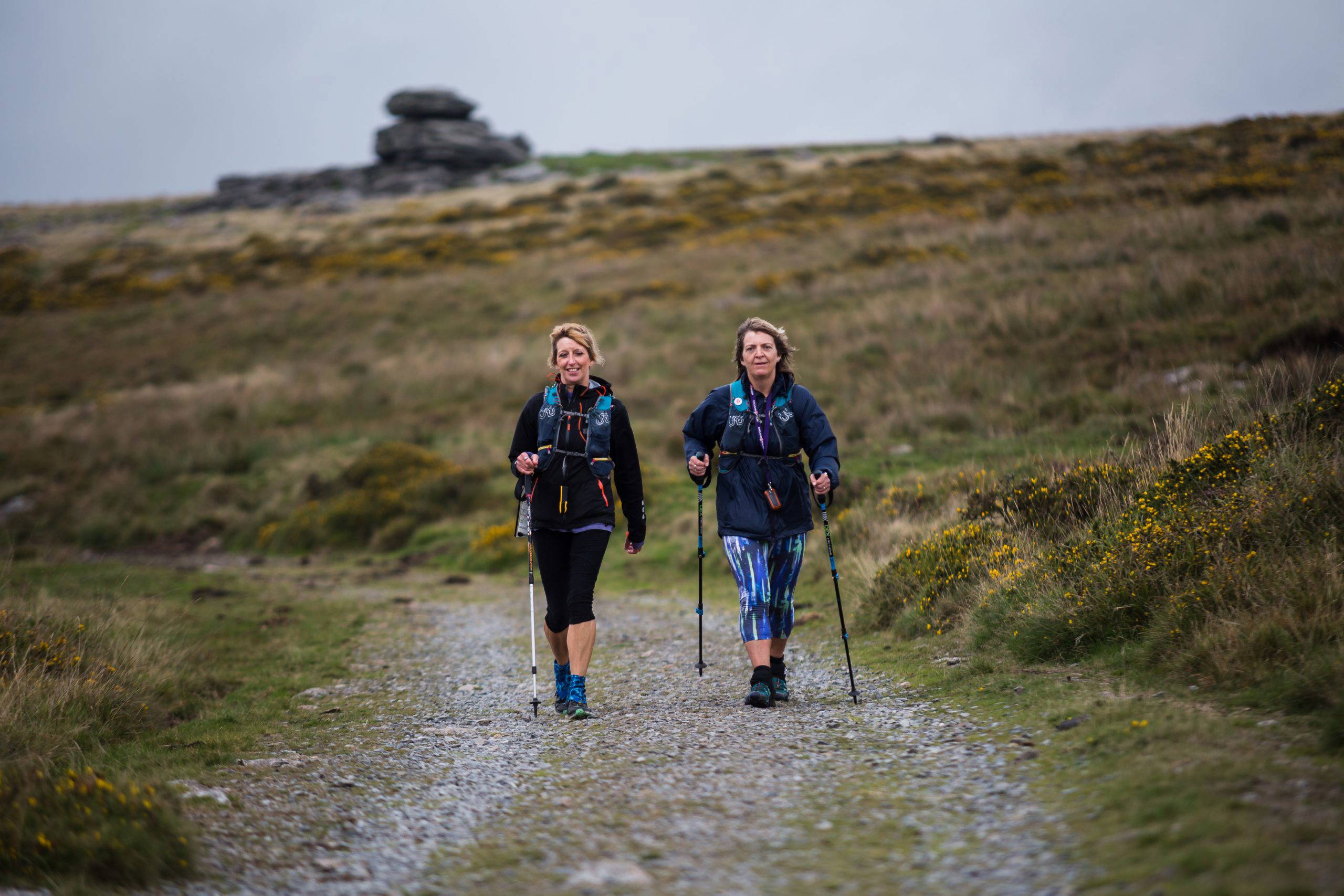 An image of two women traversing Dartmoor on a trail.