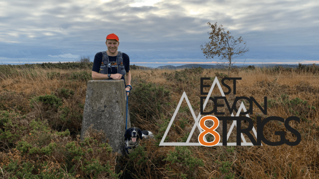 An image of a man and his dog posing for a photo in the moors.