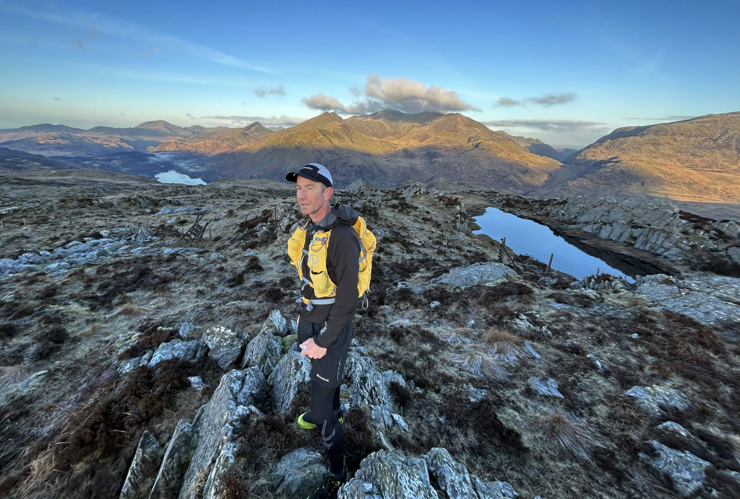 An image of a man hiking through mountainous terrain