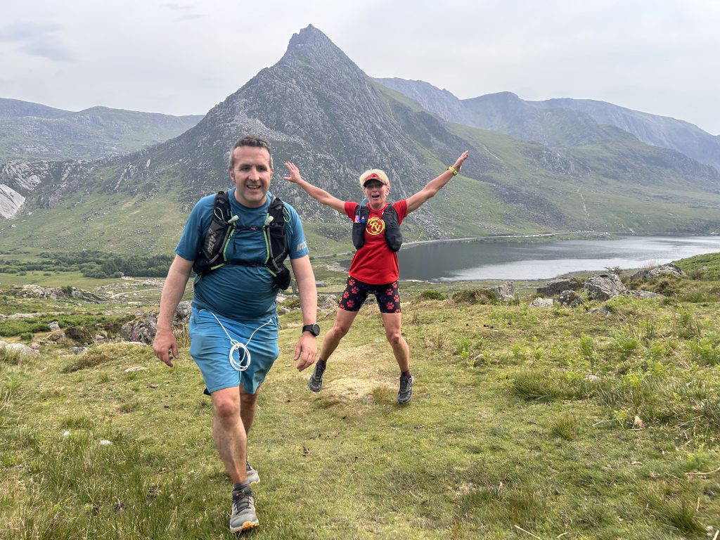 An image of a group of people jogging across natural terrain.