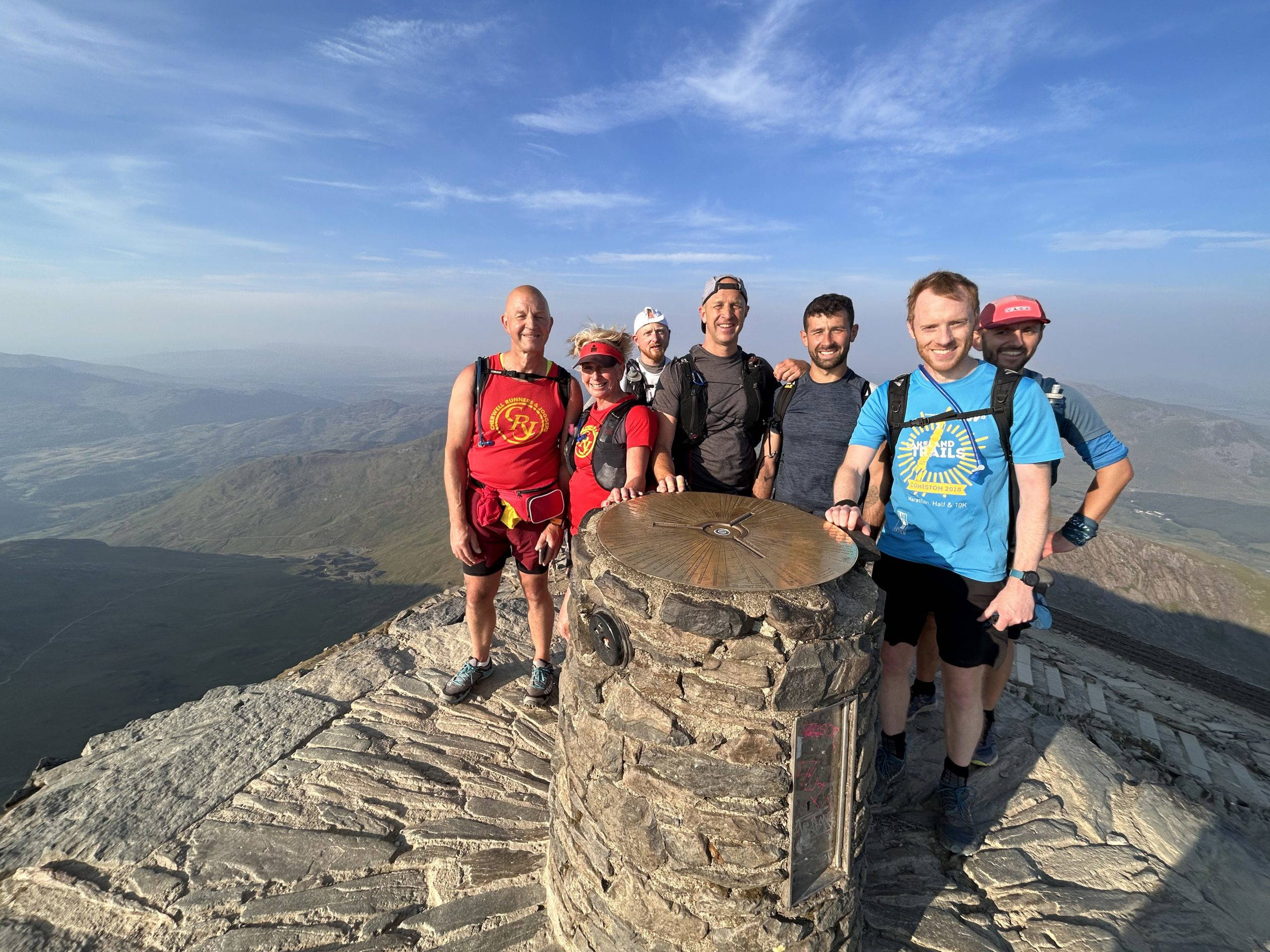 An image of a group of people jogging across natural terrain.