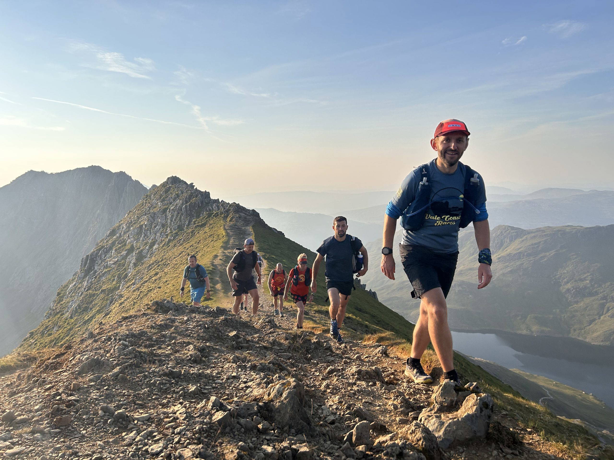 An image of a group of people jogging across natural terrain.